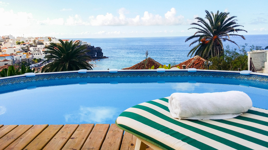 Pool mit Blick auf das Meer und Palmen in Puerto de la Cruz, Teneriffa.