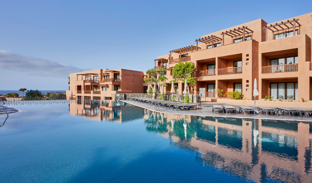 Schwimmbad und Hotelgebäude auf Teneriffa mit Meerblick.