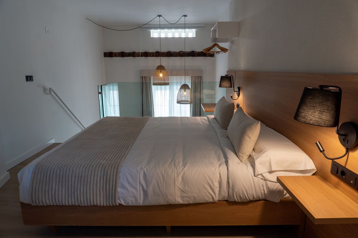 Moderne Schlafzimmer mit Holzbett und zwei Hängelampen in Tenerife.