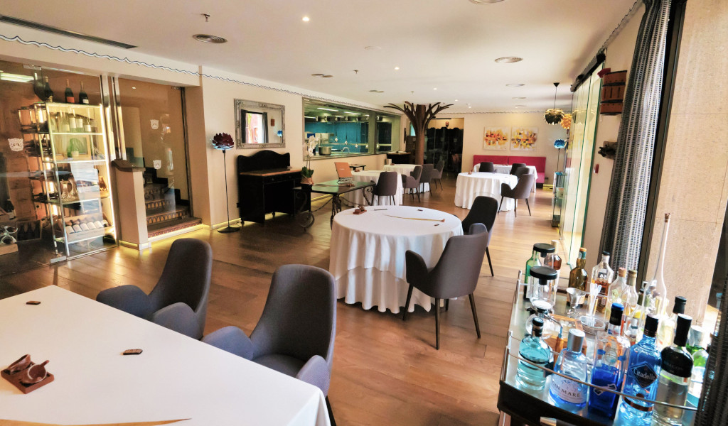 Moderne Hotelrestaurant im Puerto de la Cruz, Tischdekoration und Flaschen auf einem Wagen.