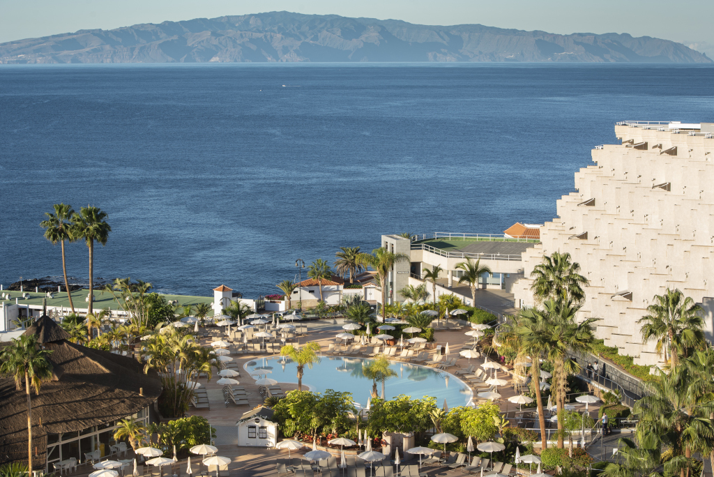 Hotelpool mit Palmen und Meerblick in Los Gigantes, Teneriffa.