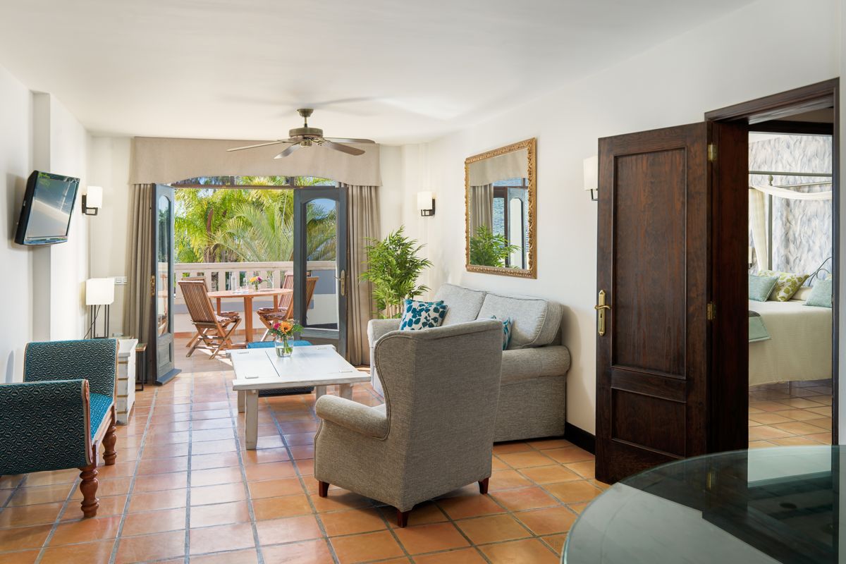 Wohnzimmer mit Terrasse und Sitzbereich in Hotelzimmer in Teneriffa.