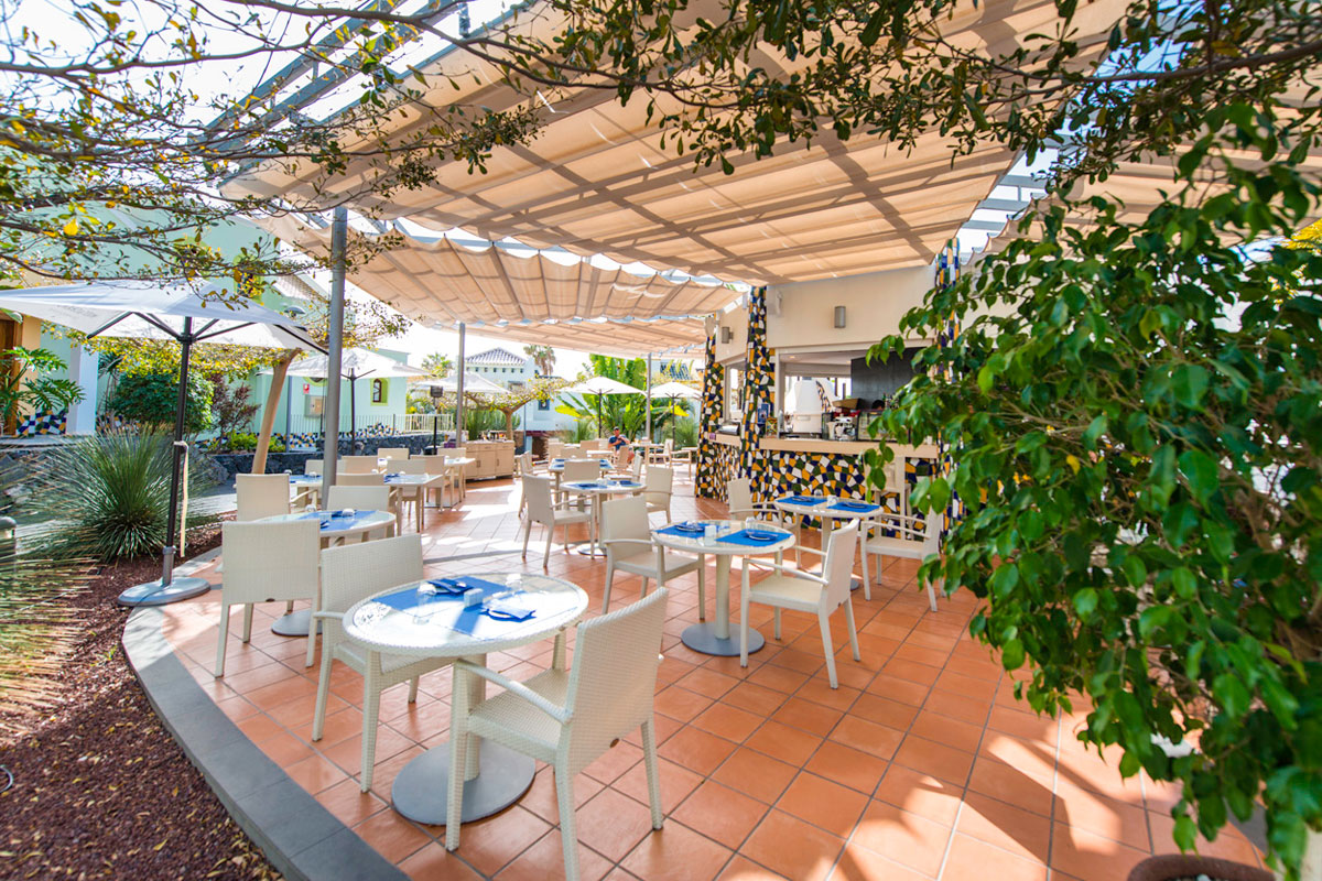 Außenbereich eines Restaurants in Santa Cruz de Tenerife mit Tischen und Stühlen.