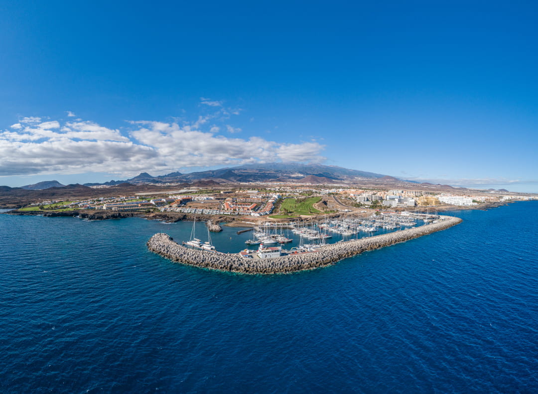 Luftaufnahme der Marina auf Teneriffa mit Bergen im Hintergrund.