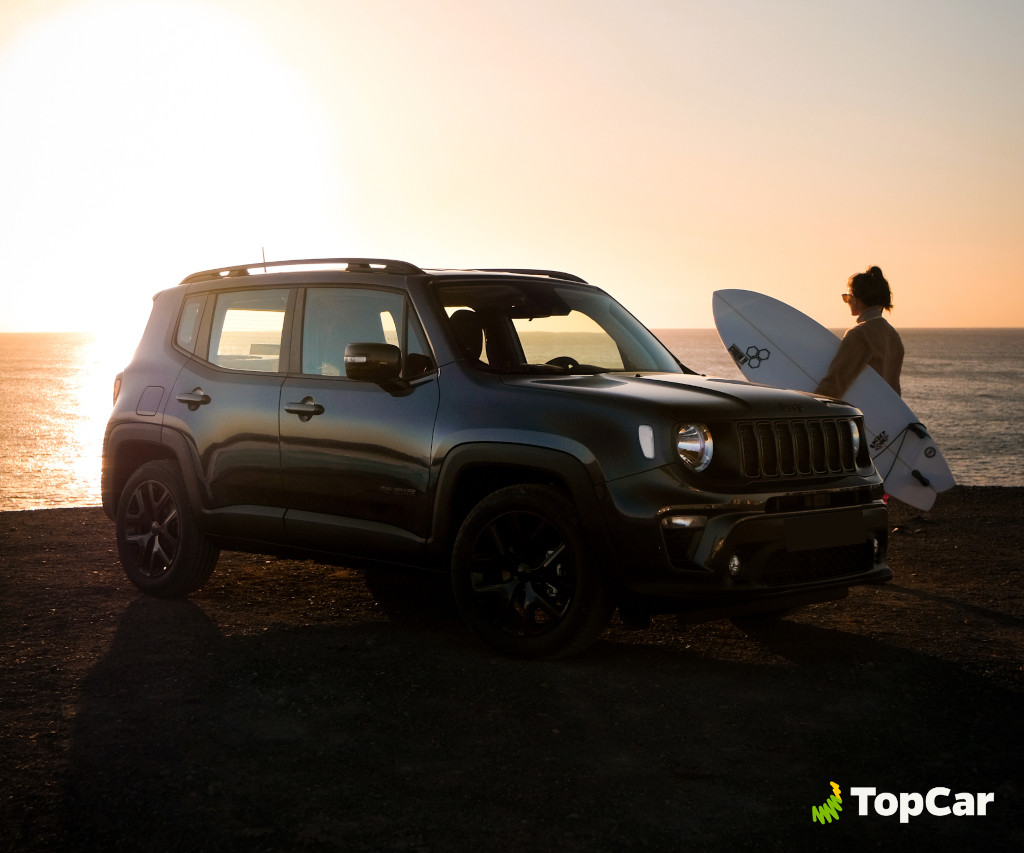 Auto bei Sonnenuntergang neben einem Surfer an der Küste von Teneriffa geparkt.