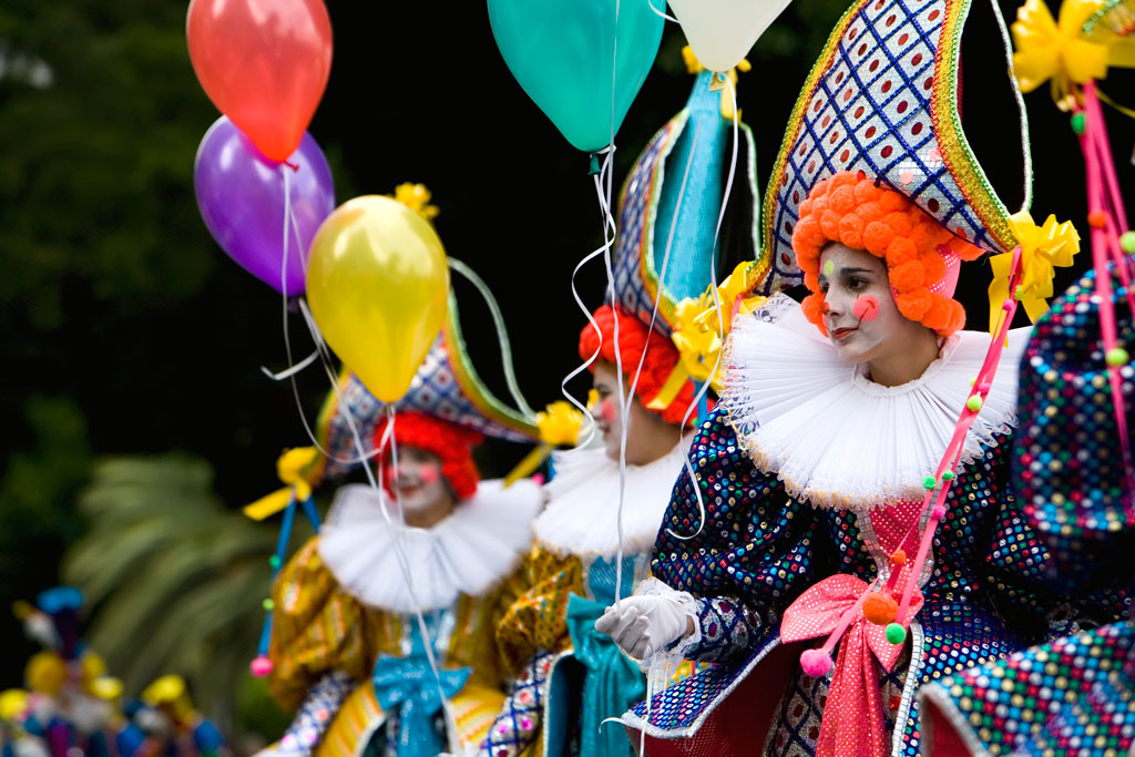 Leute, die sich als Pantomimen mit bunten Luftballons bei einer Parade auf Teneriffa verkleiden haben.