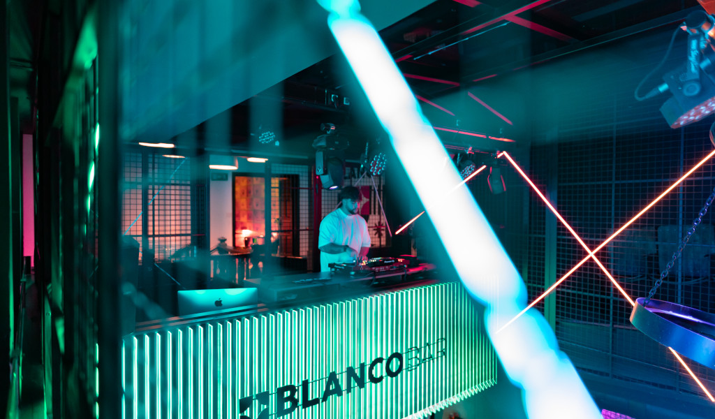 DJ spielt Musik in der Blanco Bar, Teneriffa, erleuchtet von Neonlichtern.